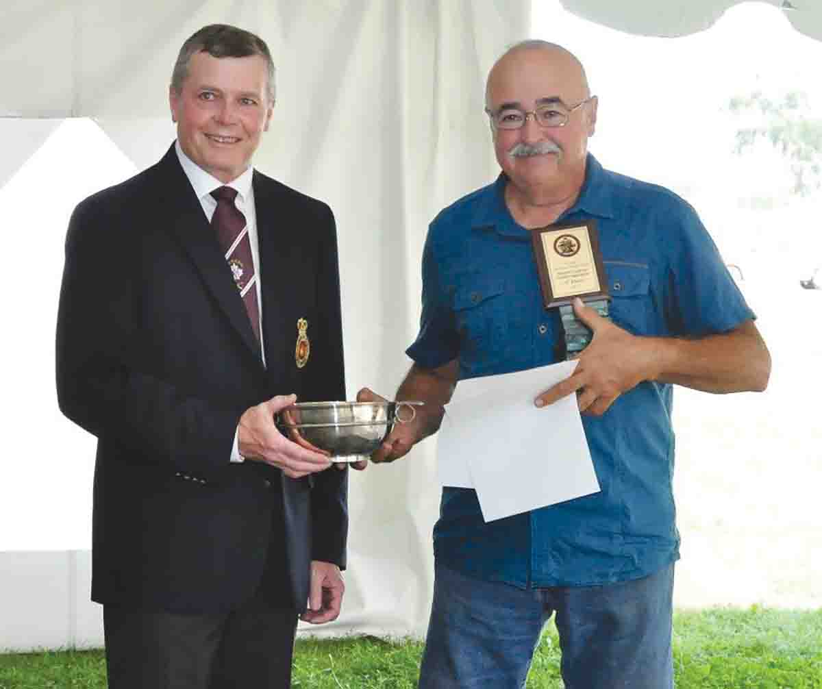 Ray Hopkins receiving the Grand Aggregate Prize as the top Muzzle Loading Class, the Quaiche Cup, from Don Haisell.